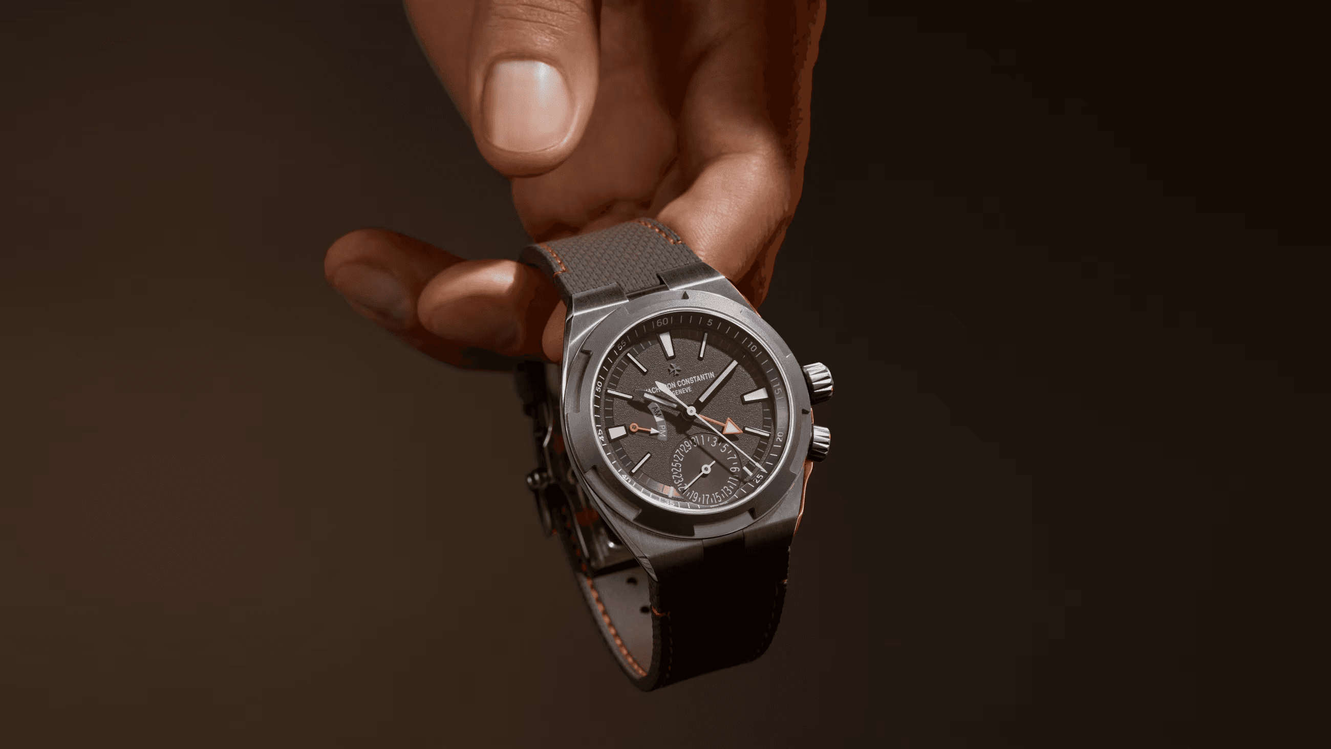 An advisor holding a Vacheron Constantin Overseas dual time